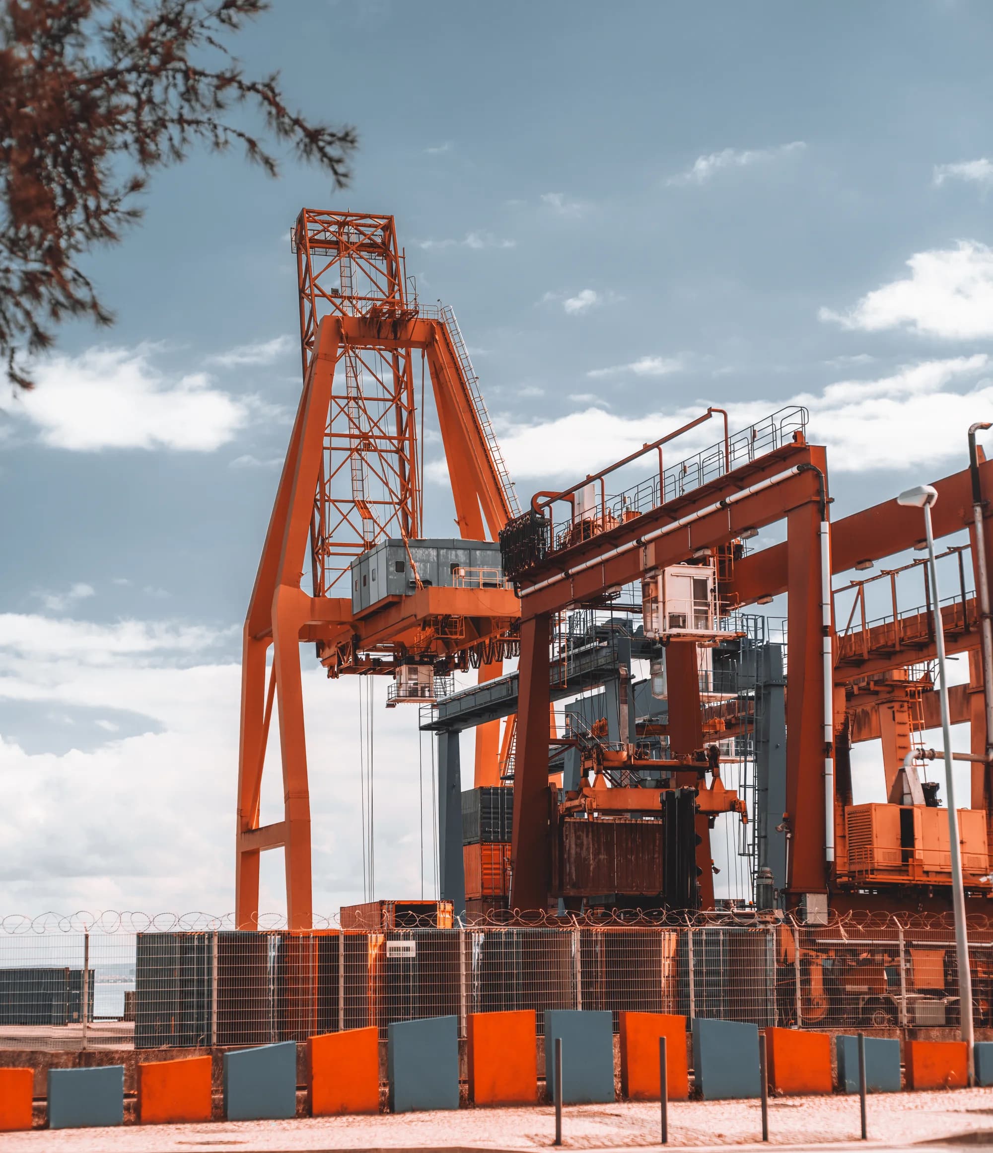 Large orange cargo crane at an industrial port terminal