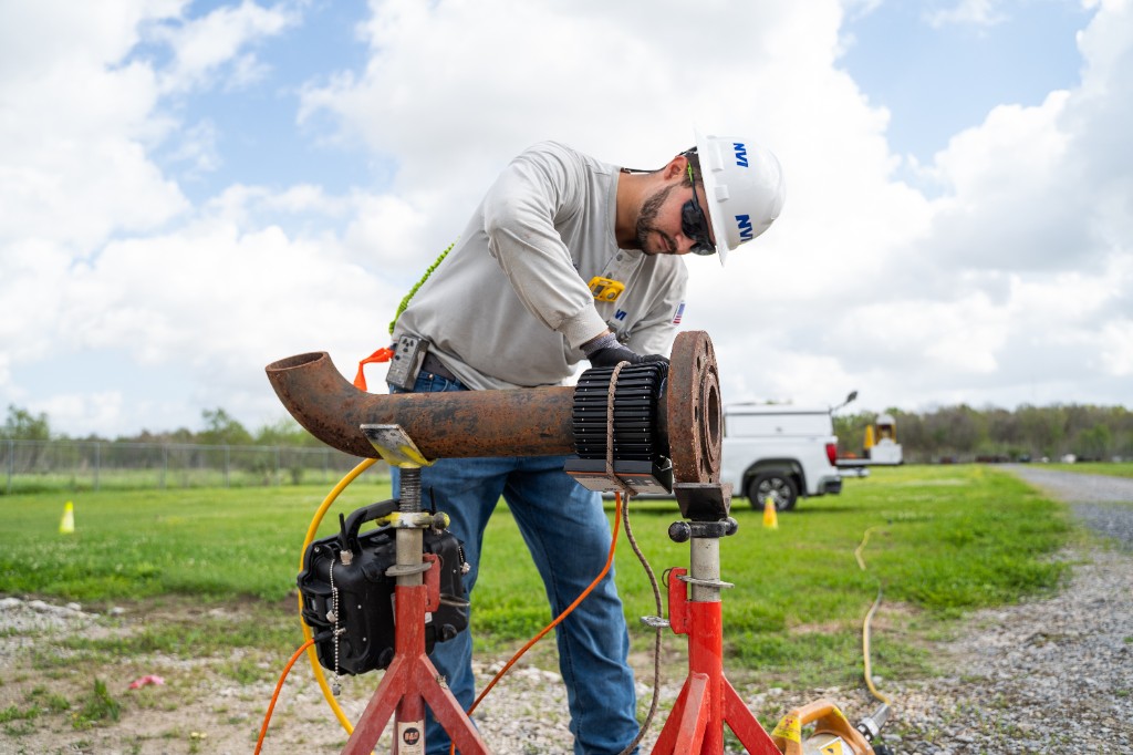 NVI technician using flexible digital detector on pipe